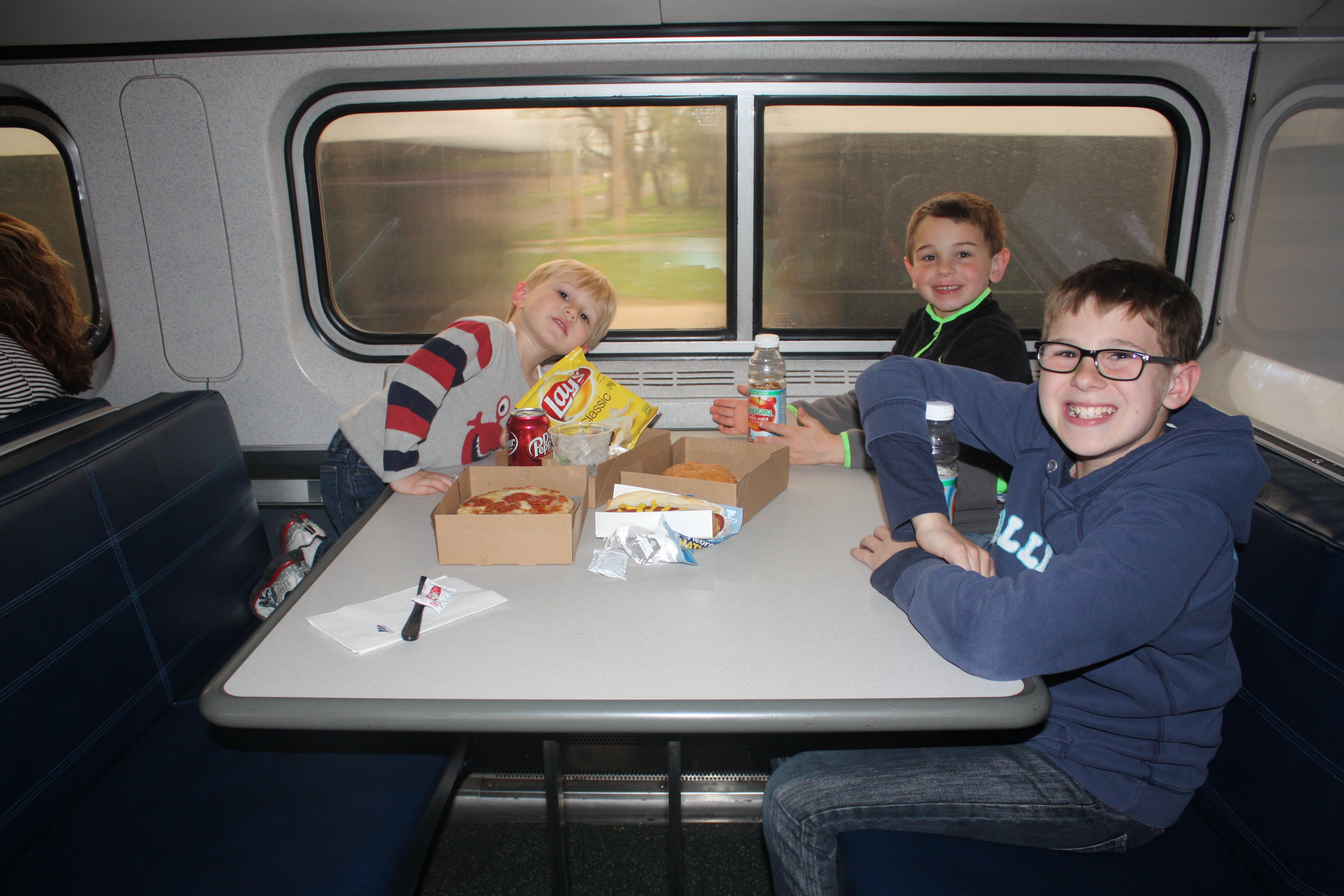 3 boys in dining car of Amtrak train
