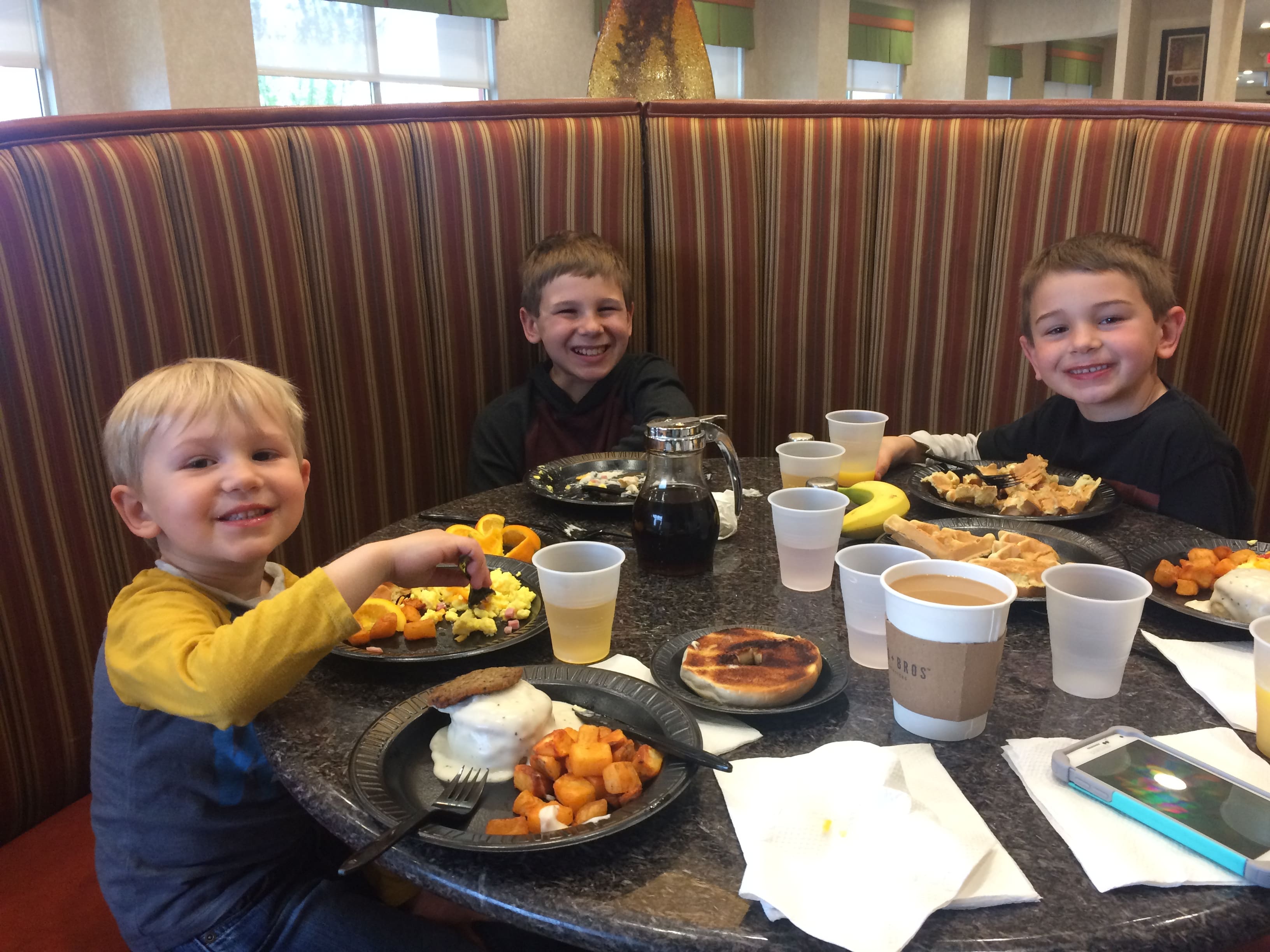 3 boys eating free breakfast at Drury Hotel